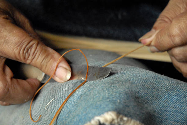 istock Craftsman hands sewing working with vegetable fiber 1935297783