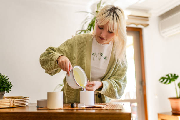 istock Young woman making scented soy candles for her small business 1935308242