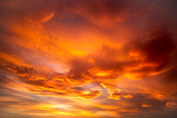 istock Dramatic sky with high clouds at sunset with different orange, yellow and pink colors 1935318309