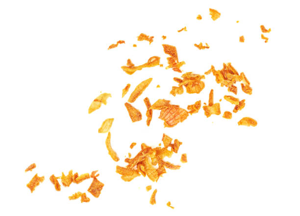 istock Flying  Roasted Onions pieces isolated on white background. Cryspy fried onions Top view. Flat lay 1935321410