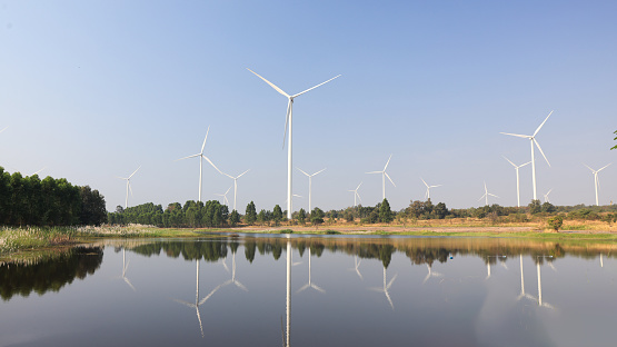 Wind turbine beside reservoir in upcountry field, Wind Turbine farm in farmer field, Renewable energy, Green technology