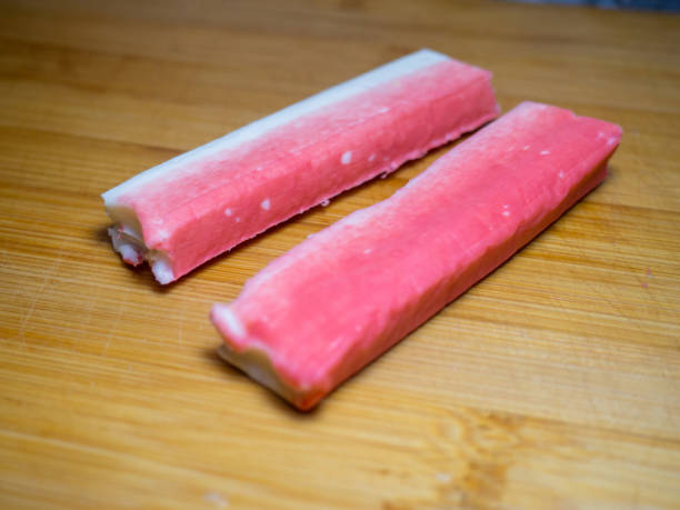 istock Crab sticks without packaging. Ingredient on cutting board. Fish salad ingredient. Ingredient for salad. 1935341604