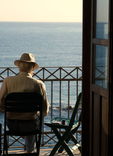Artist sketching, looking over the Mediterranean