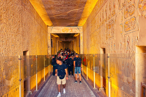 White Man Tourist inside of the Pharaoh tomb in the Valley of the Kings in Luxor, Egypt