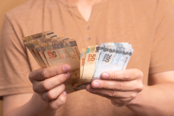 istock hands of man with money 1935370392