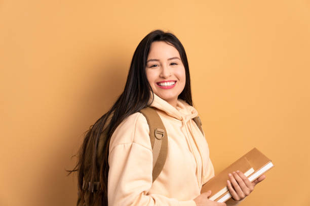 istock college student holding academy book and smiling 1935371986