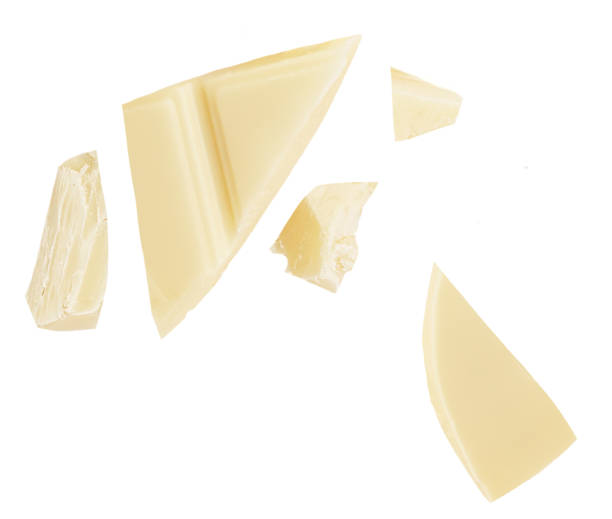 istock  Levitating white milk chocolate chunks isolated on white background. Flying Chocolate pieces explosion, shavings and cocoa crumbs Top view. Flat lay 1935374127