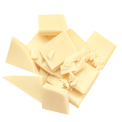 Broken white chocolate pieces  isolated on white background. Cubes of irregular chocolate shape for package design. Top view. Flat lay
