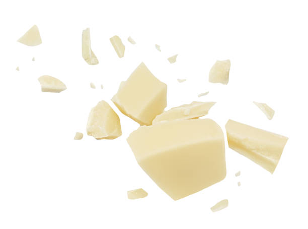 istock  Levitating white milk chocolate chunks isolated on white background. Flying Chocolate pieces explosion, shavings and cocoa crumbs Top view. Flat lay 1935374665