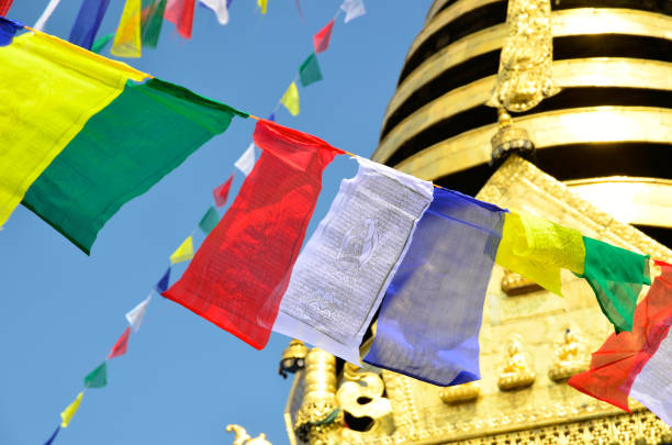 Colorful Tibetan prayer flags on blurred Kathmandu cityscape background symbolizing cultural value and spiritual heritage of Nepali region, connection between earthly and spiritual realms