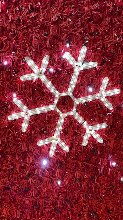 New Year's decorations in the form of white stars, red background in the night city