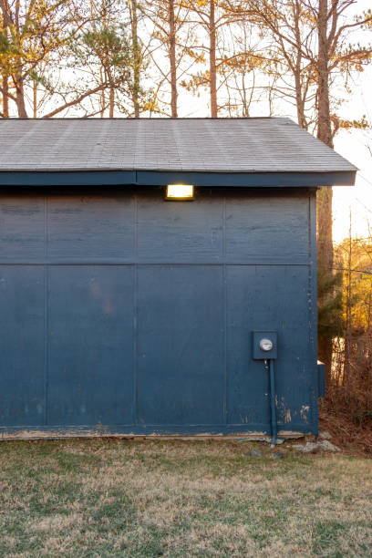 istock Old blue wooden structure with a flood light and power meter. 1935415111