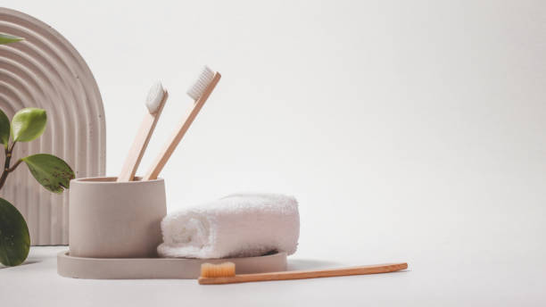 istock Bamboo toothbrushes in a stylish concrete glass on a white background 1935416713