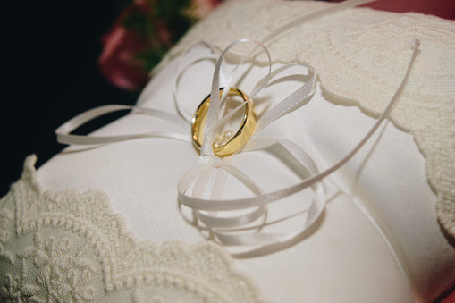 Image of wedding rings on the pillow