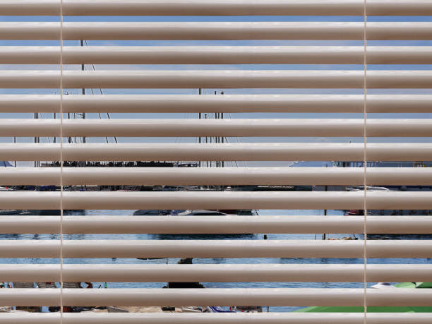 istock View over window blinds on sea port under clear blue sky 1935420849