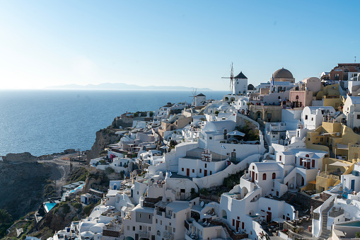 Oia town traditional white houses and churches with blue domes over the Caldera, Aegean sea