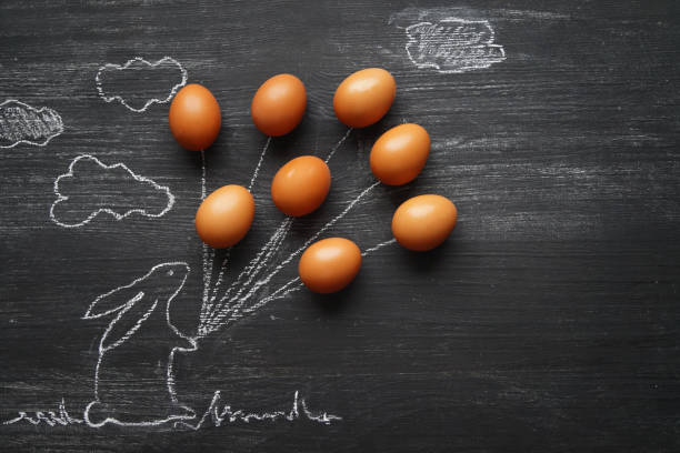 Fresh organic chicken eggs in a row in the dark background with copy space. Perfect condition eggs