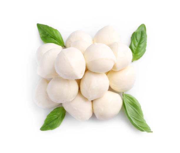 istock Tasty mozzarella balls and basil leaves isolated on white, top view 1935459668