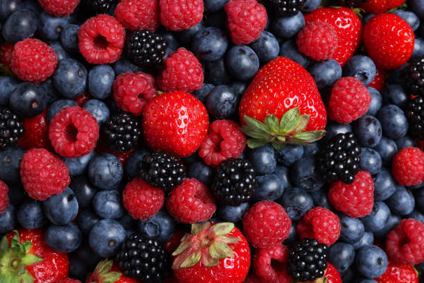 istock Different fresh ripe berries as background, top view 1935469817