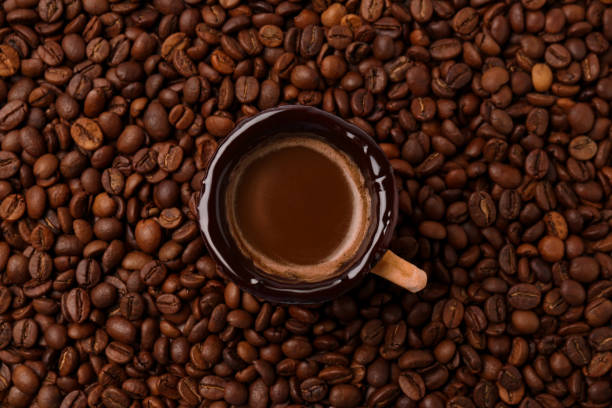 istock Delicious edible biscuit cup with espresso on roasted beans, top view 1935479377