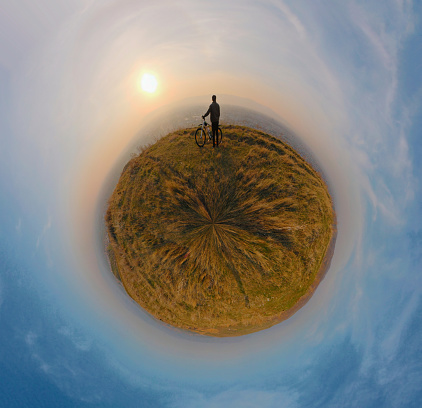 Panoramic photo in the little planet style with a cyclist on it
