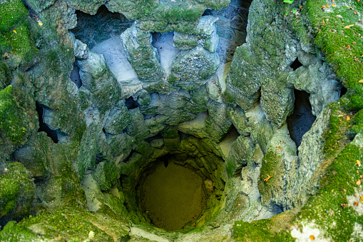 Sintra, Portugal - Oct. 3 2023: Unfinished Initiation Well. View in the park of The Regaleira Palace - Quinta da Regaleira, Sintra, Portugal.