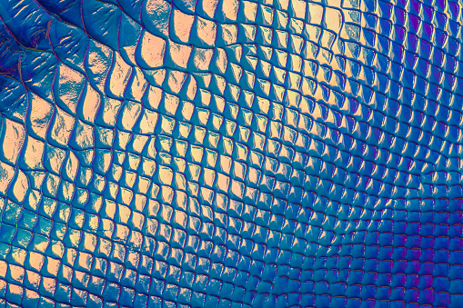 Artificial leather fabric with a pattern resembling snake scales.