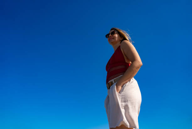 Beautiful woman walking on sunny beach