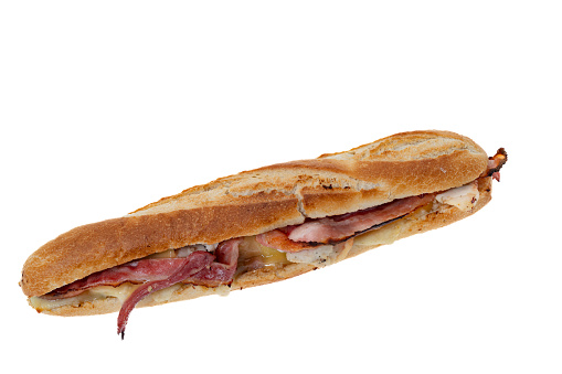 Christmas sub sandwich with turkey, sausage, bacon and stuffing - white background