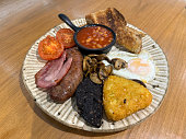 Full English breakfast with fried eggs and black pudding