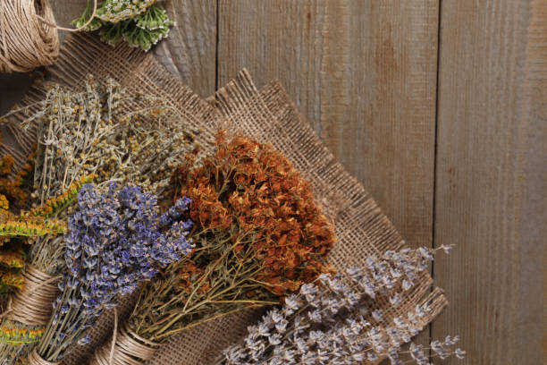 istock Different dry herbs and burlap fabric on wooden table, flat lay. Space for text 1935568139