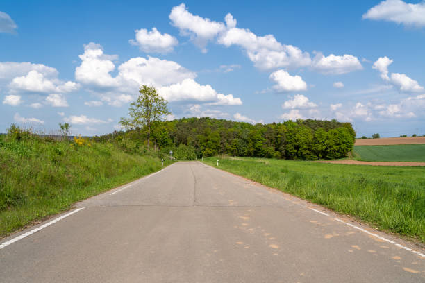 istock Road in the landscape with blue sky 1935576626
