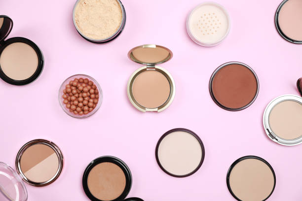 istock Different face powders on pink background, flat lay 1935582997