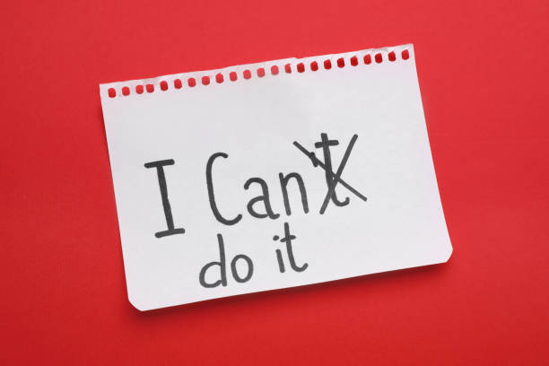 istock Motivation concept. Changing phrase from I Can't Do It into I Can Do It by crossing out letter T on red background, top view 1935589246