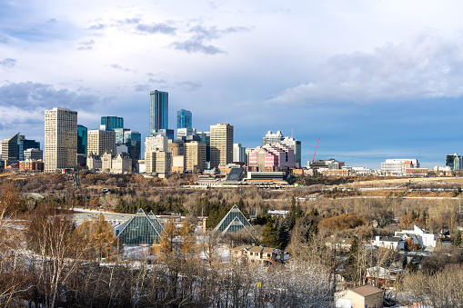 Edmonton, Canada, December 10, 2023: Cityscape with   highrises on dark sky clouds background in winter season