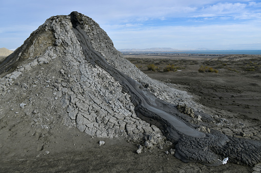 Gobustan, Azerbaijan: concrete-like mud spewing out from a mud volcano - Azerbaijan has the most mud volcanoes in the world, with around 300 of them, around a third of all mud volcanoes in the world, some thought to have medicinal qualities. Their occurrence in the area around Qobustan is closely linked to the local oil and gas deposits.