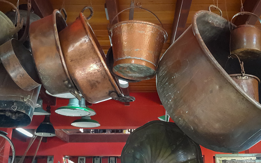 set of bronze pots hanging in a kitchen