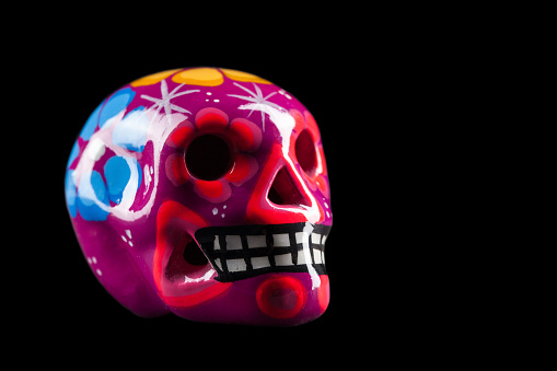 Mexican Souvenir Skull with many colors isolate on black
