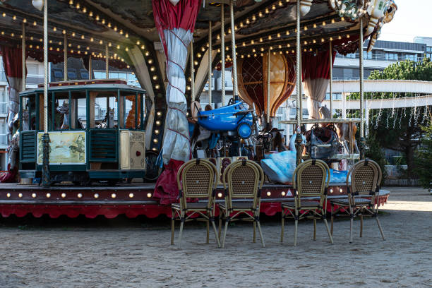 Chairs in front of a vintage wooden merry-go-round for children