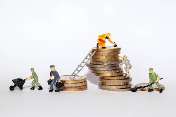 istock Miniatures on stacks of money 1935644870