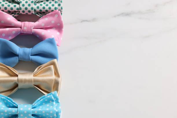 istock Stylish color bow ties on white background, flat lay. Space for text 1935644941