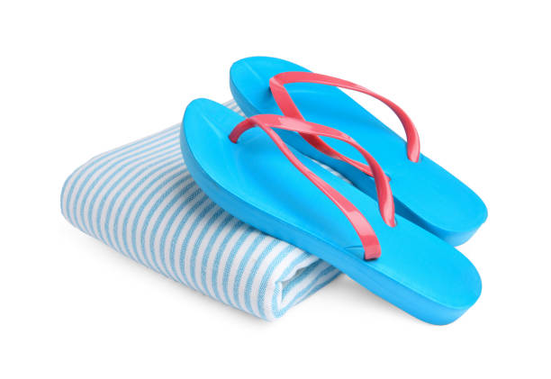 istock Stylish flip flops and beach towel isolated on white 1935645082