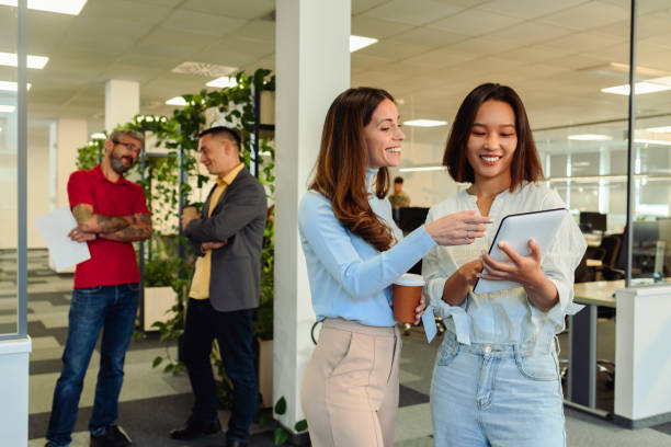 istock Two young diverse businesswoman using a digital tablet in the office 1935645226