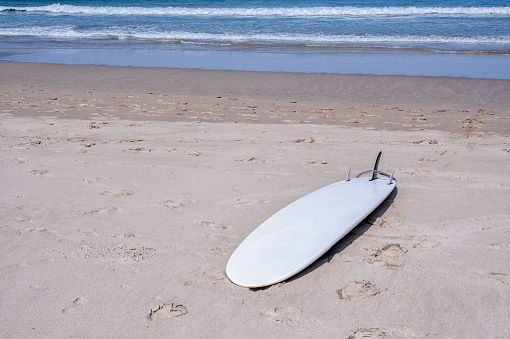 Surf board on the beach awaiting fun in the sun