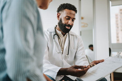 Doctor talking to patient holding clipboard