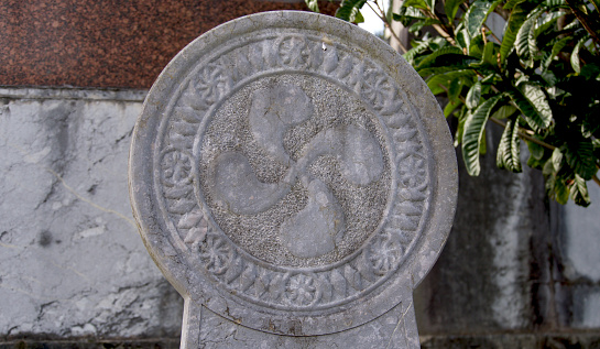 solar symbol carved in stone in a Basque cemetery