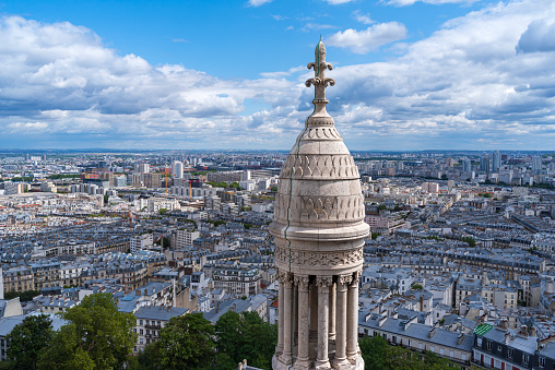 aerial view of paris and basilica cupola atop dome reaching above horizon