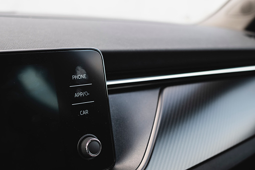 Many fingerprints on a touchable infotainment black screen interior car