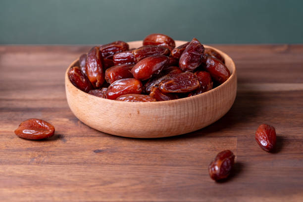 istock fruits dates. dried dates in a wood pot 1935725706
