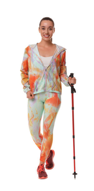istock Woman with pole for Nordic walking isolated on white 1935727272